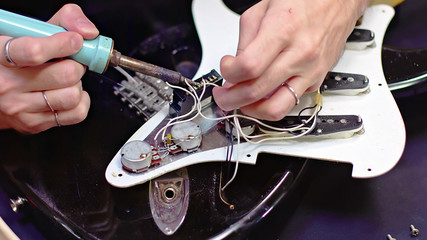 Repairing the interior electrical parts of a guitar