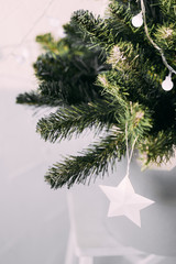 Minimalist Christmas tree with white decorations. Christmas and New Year concept.