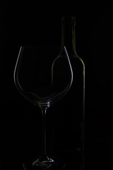  glass of red and pink wine on a black background. Wine list menu. Close up of the power of glasses and bottles in low key