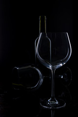  glass of red and pink wine on a black background. Wine list menu. Close up of the power of glasses and bottles in low key