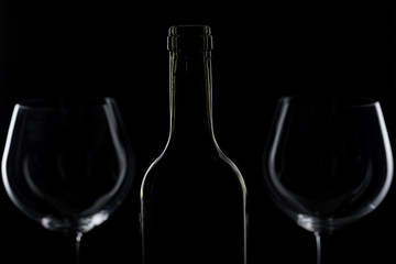  glass of red and pink wine on a black background. Wine list menu. Close up of the power of glasses and bottles in low key