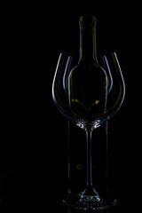  glass of red and pink wine on a black background. Wine list menu. Close up of the power of glasses and bottles in low key
