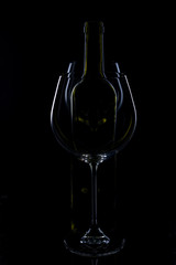  glass of red and pink wine on a black background. Wine list menu. Close up of the power of glasses and bottles in low key