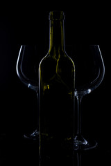  glass of red and pink wine on a black background. Wine list menu. Close up of the power of glasses and bottles in low key
