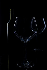  glass of red and pink wine on a black background. Wine list menu. Close up of the power of glasses and bottles in low key