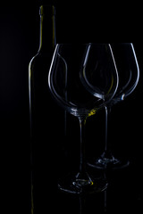  glass of red and pink wine on a black background. Wine list menu. Close up of the power of glasses and bottles in low key