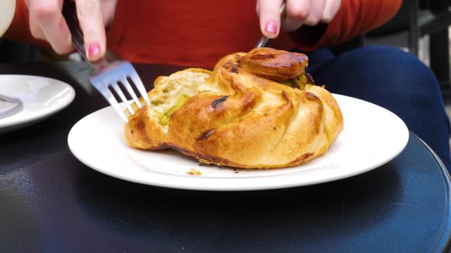 Cutting into a tasty Qassatat, otherwise known as a Pastizz, in Malta