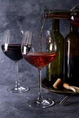 Red wine. Bottle and glass of red wine. Vintage style. Red wine on a black background. Design with space for your text.