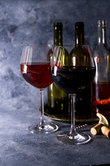 Red wine. Bottle and glass of red wine. Vintage style. Red wine on a black background. Design with space for your text.