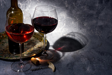 Red wine. Bottle and glass of red wine. Vintage style. Red wine on a black background. Design with...