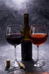 Red wine. Bottle and glass of red wine. Vintage style. Red wine on a black background. Design with space for your text.
