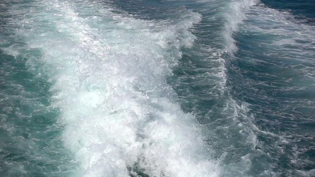 Cruise ship wake Pacific ocean behind a large cruise ship at sea. Destination vacation travel tropical ocean sea. Beautiful deep blue Caribbean Ocean water wake behind large cruise ship. A slow motion