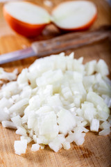 Chopped onions on wooden cutting board