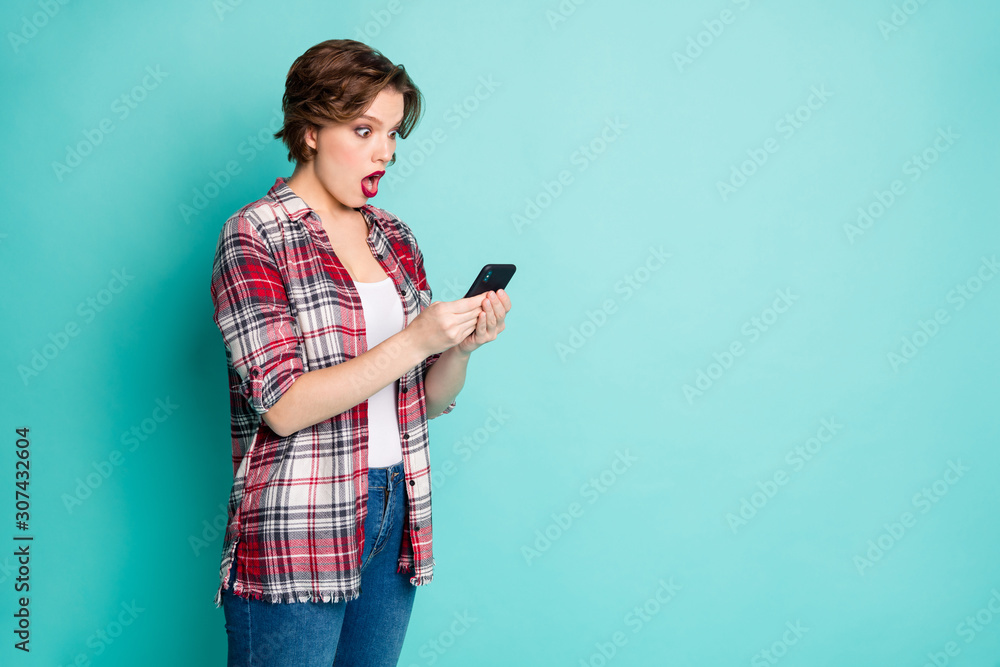 Canvas Prints Portrait of astonished girl use cell phone read wonderful social network information impressed scream wow omg wear stylish clothing isolated over turquoise color background