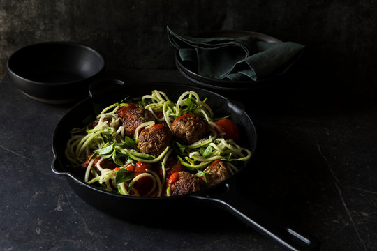 Zucchini noodles with meatball in saucepan