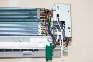 Split air conditioner closeup repair and maintenance concept. The specialist repairs the wall air conditioner. Inverter Air conditioning service