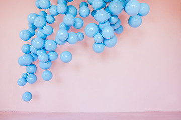 pink wall with blue balloons. Empty space. Background