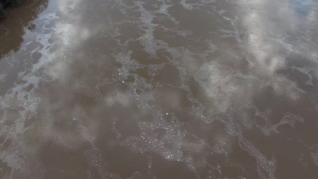 Dirty and cloudy water with evidence of pollution. Aerial video of PO River in the province of Reggio Emilia, Italy