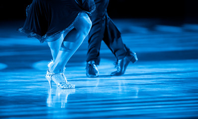 Woman and man dancer latino international dancing.Blue filter
