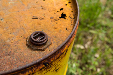 Yellow old rusty damaged oil barrel