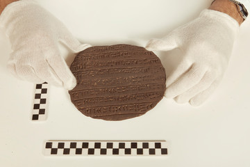 Scientist in museum office working on cuneiform find