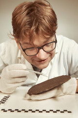 Scientist in museum office working on cuneiform find