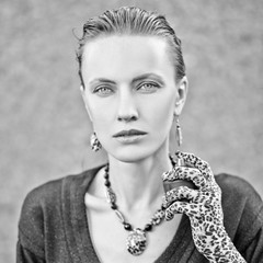 Portrait of beautiful young woman with perfume bottle