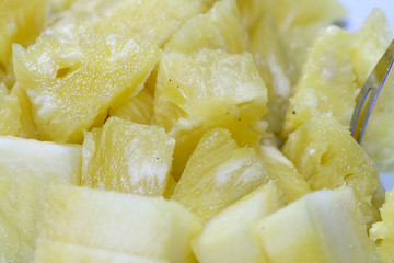 Close up slice pineapple background texture in white dish. Slide and piece of fresh fruit.