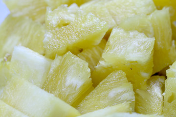 Close up slice pineapple background texture in white dish. Slide and piece of fresh fruit.