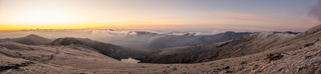 Fototapeta na wymiar Sunrise on frozen mountains of Snowdonia National Park, Wales, UK