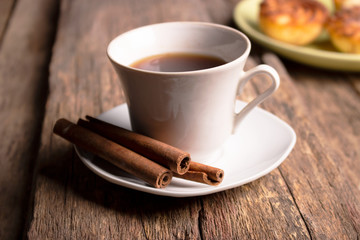 Tea with cinnamon flavor on an old wooden board