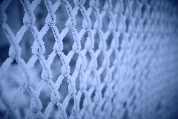 Mesh netting covered with frost after heavy fog and frost.