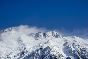 Close up shot of Mount Cook's peak cover by snow in winday sunny day.Mount Cook located in Hooker Valler,New Zealand.