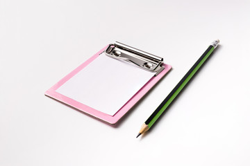 little pink paper clipboard. short note to paper with pencil. office equipment. blank paper clipboard for task checklist. holding clipboard in hand for writing survey