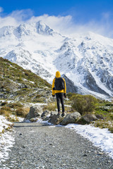 A man hiking in snow mountain.Hiking the Hooker Valley track in Mount Cook,New Zealand.