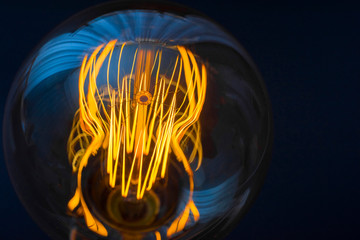 Beautiful large round retro lamp with incandescent threads. Close-up. Creativity concept.