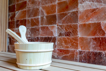 Traditional  wooden sauna for relaxation with bucket of water