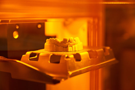 Dental cast placed inside muffle furnace during artificial denture production in laboratory