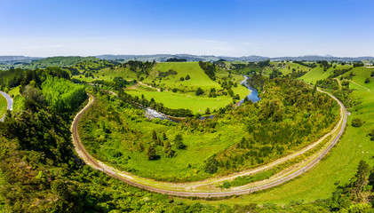 New Zealand. Aerial view of river, hills, green meadows and mountains. Drone shot.