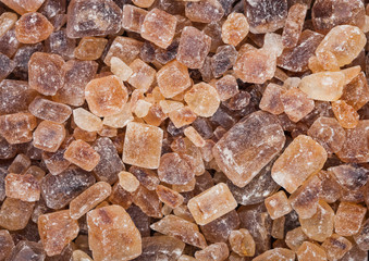 Close-Up shot of natural caramelized sugar cubes on white background.