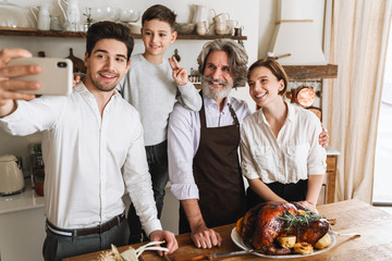 Happy cheerful family taking a selfie while celebrating