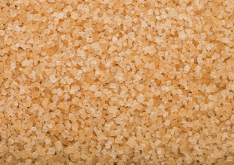 Close-Up shot of natural brown refined sugar cubes on white background.