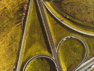 Drone view of morning empty country side road with beautiful green landscape around