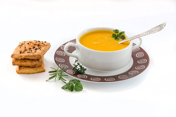 Pumpkin soup with cake and herbs