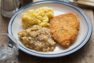 Breaded chicken breast with mashed potatoes and cabbage 