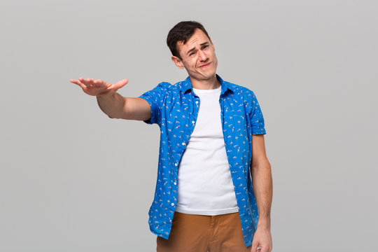 Man in uncertain if he likes or dislikes the object.
