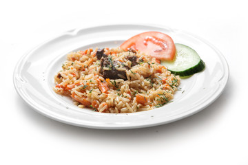 Traditional oriental pilaf with mutton, uzbek pilaf on a white plate on white background