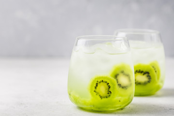 Iced kiwi cocktail in glasses. Selective focus, space for text.