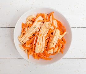 salad with soy asparagus and carrots on a white plate. vegetarian soy salad on a plate on a white background. healthy eating