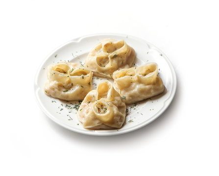 Traditional uzbek manti steamed with minced meat. Homemade manti on white plate.